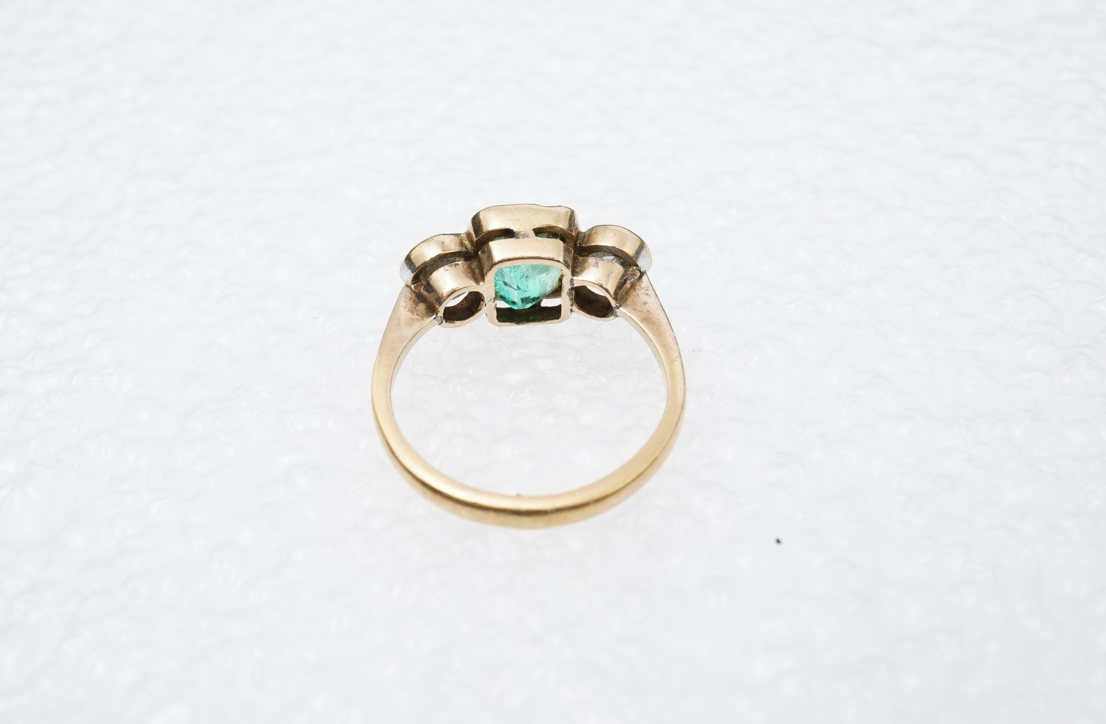 An emerald and diamond ring